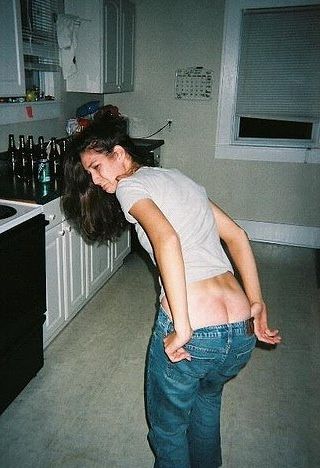 woman in kitchen with beer bottles and a well-spanked bottom