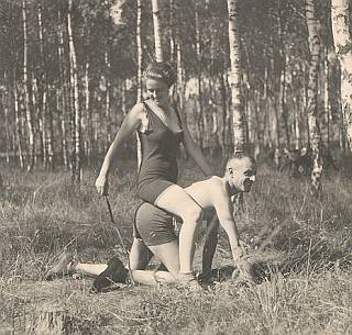 woman riding her man and encouraging him with a stick