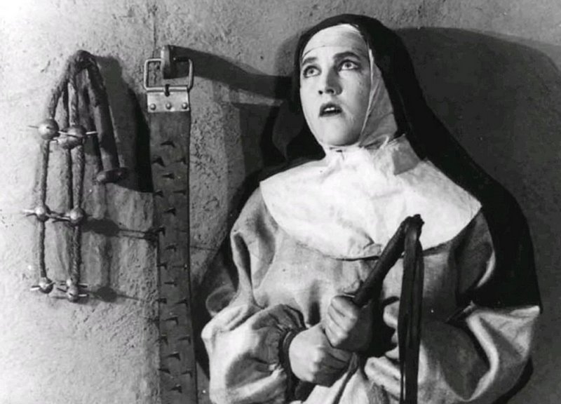 concerned nun holds a whip