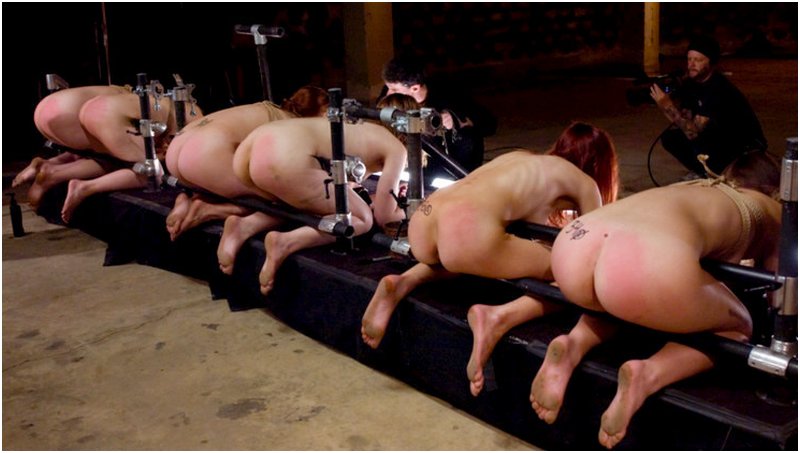 six women kneel in bondage on a punishment bench