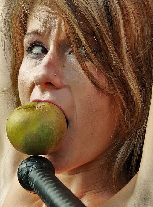gagged with an apple in her mouth during a pussy whipping