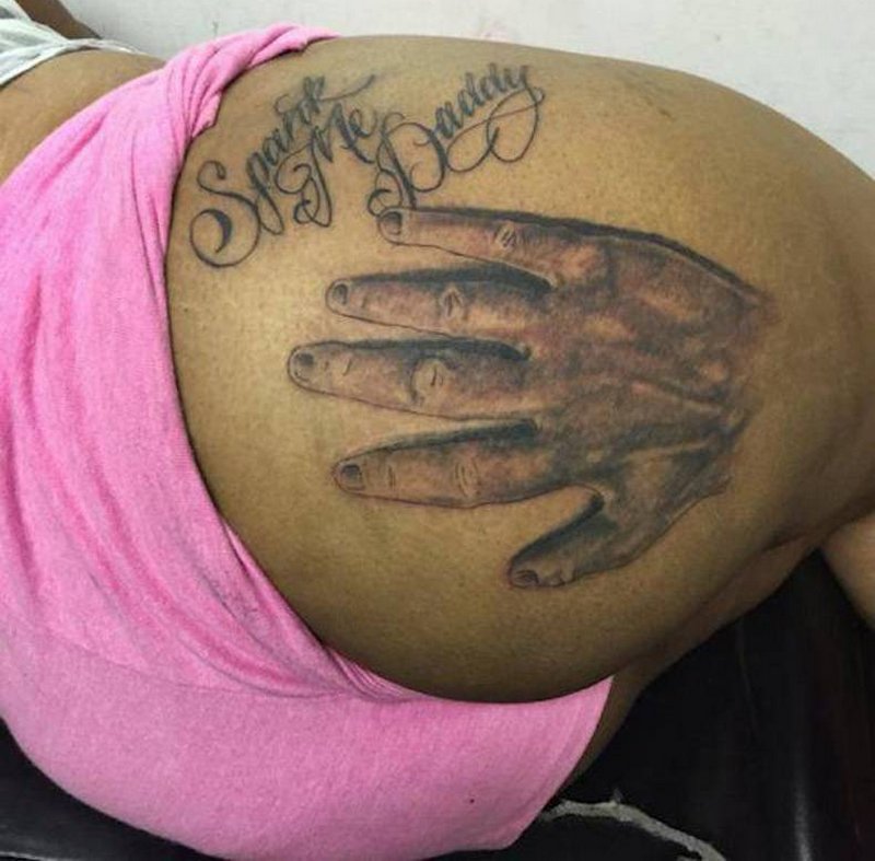 huge spank me daddy tattoo with a big open hand