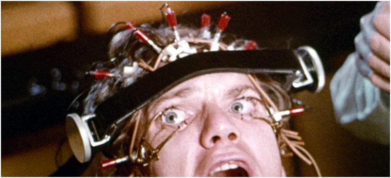 scene from clockwork orange with eyes forced open for reeducation propaganda viewing and rehabilitation