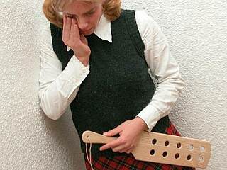 crying schoolgirl after her paddle spanking