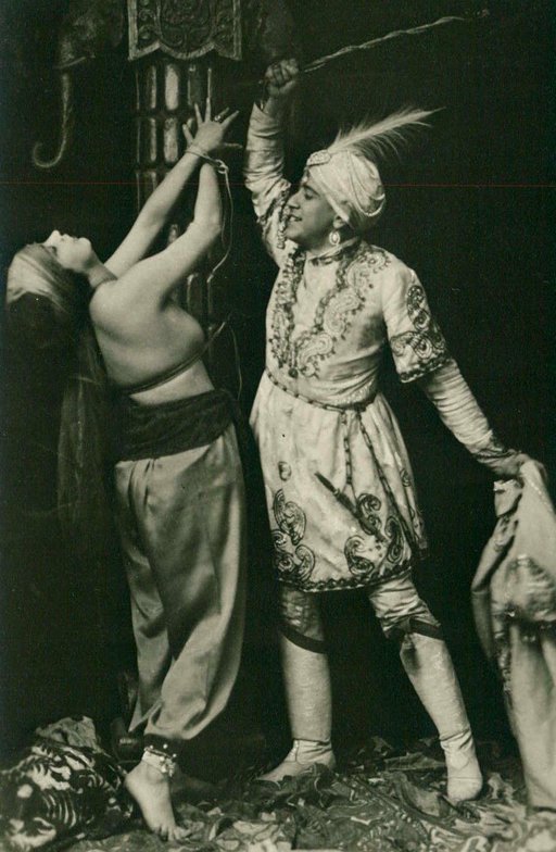 cheesy pasha menaces badly-restrained harem girl with a whipping