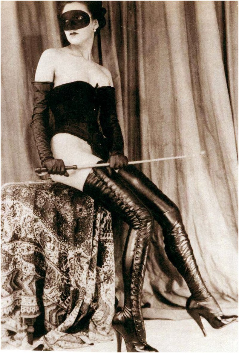 celine masked dominatrix with a cane