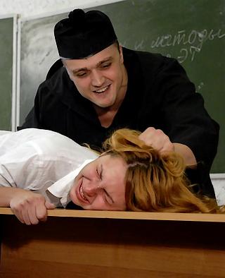 brutal Russian instructor leers over the crying face of a severely punished Russian school girl