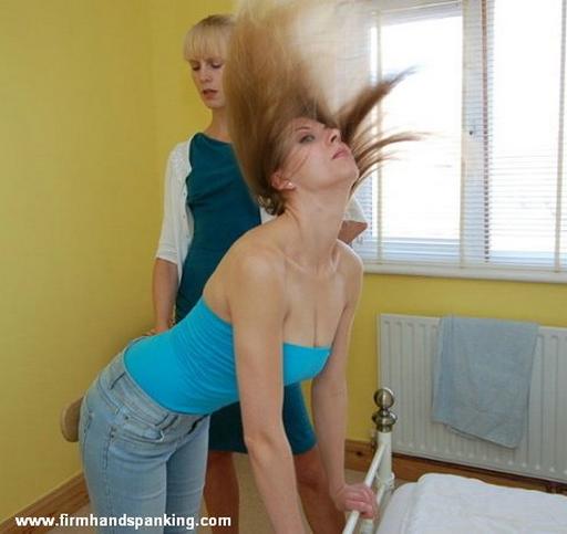 her hair goes flying as she reacts to a strong paddle swat