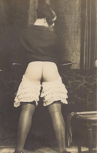 presenting her bare bottom for punishment