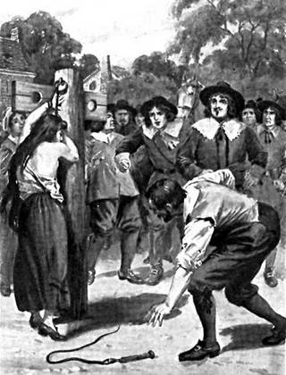 tied to the whipping post for a humiliating topless public punishment