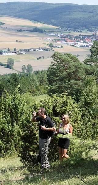 man and girl climb whip mountain on a beautiful sunny day
