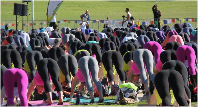 sixty women bent over in tights with their asses in the air -- is it yoga or a mass public punishment?